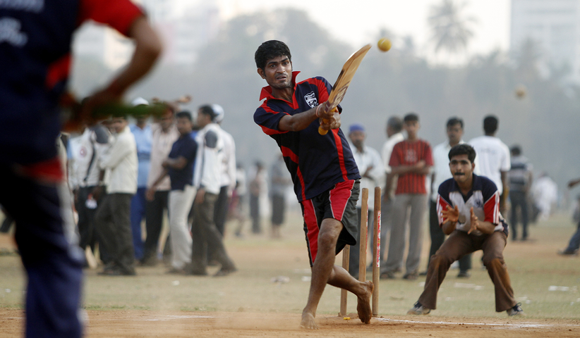 Playing cricket in the park Oval Maidan in Mumbai, India, 2011